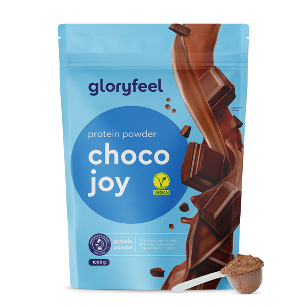 Proteina Choco Joy de gloryfeel GmbH España, presentada con trozos de chocolate y una cuchara para el polvo, también cuenta con una etiqueta vegana.