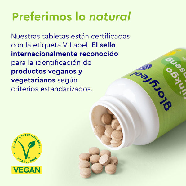 Una botella de Tabletas de Ginkgo Ginseng de gloryfeel GmbH España incluye un texto en español que promociona la certificación V-Label para productos veganos y vegetarianos. La etiqueta verde &quot;VEGAN&quot;, con el logotipo, indica ingredientes naturales como el Ginkgo Biloba, inspirados en los principios de la medicina tradicional china.