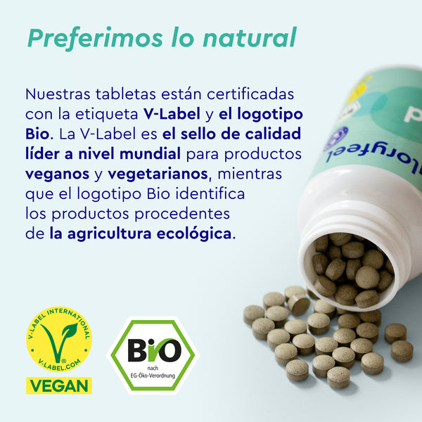 Se derrama un frasco de tabletas BIO Yodo de 225 µg, con los logotipos V-Label y Bio, que garantizan la certificación vegana y orgánica de gloryfeel GmbH España. Los detalles verdes resaltan su enfoque natural.